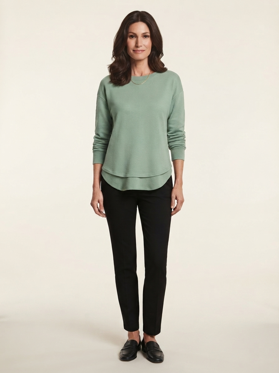 Model wearing green asymmetric stitch knit sweater