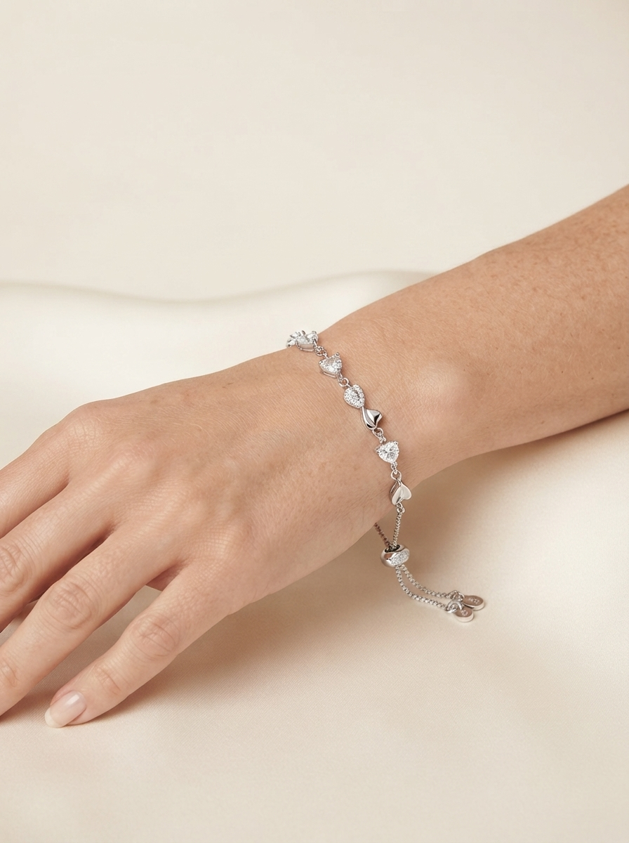 Close-up of model wearing white crystal heart bracelet