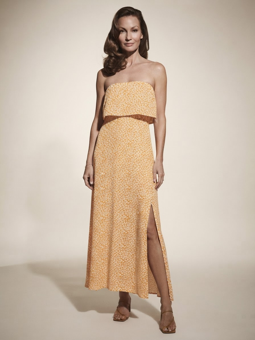 Model wearing yellow floral tube top dress with slit