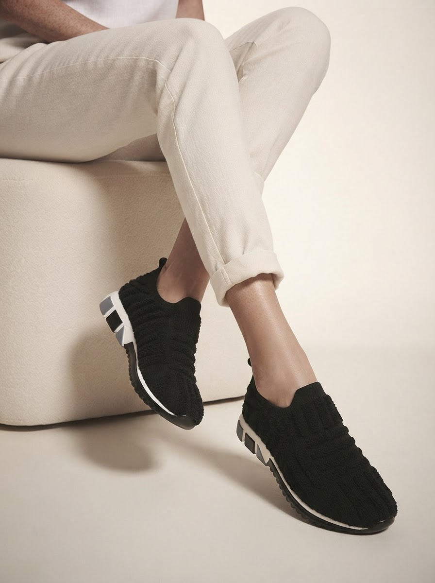 Close-up of model wearing black cushioned support sneakers
