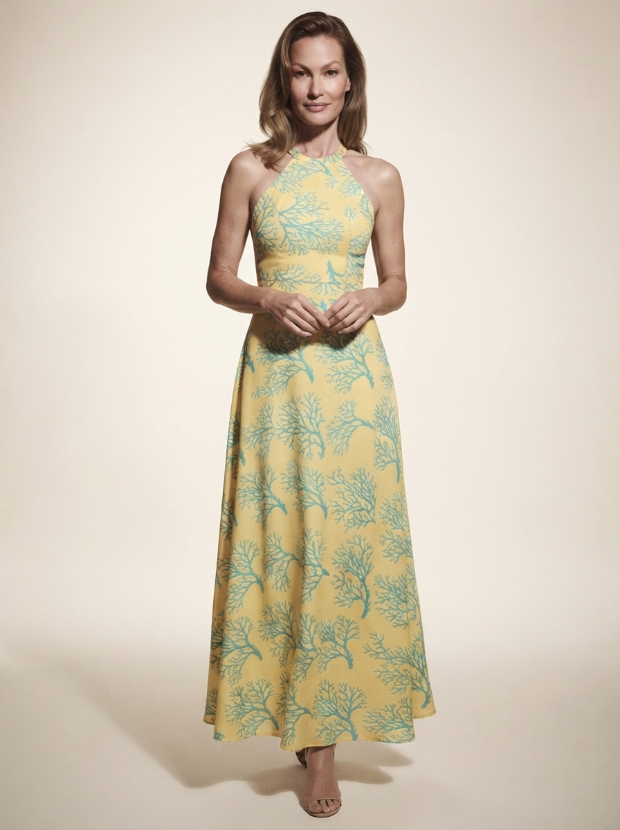 Model wearing yellow halter neck printed midi dress