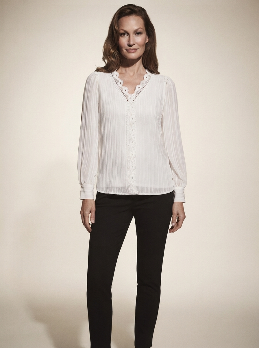 Model wearing white chiffon blouse with lace details