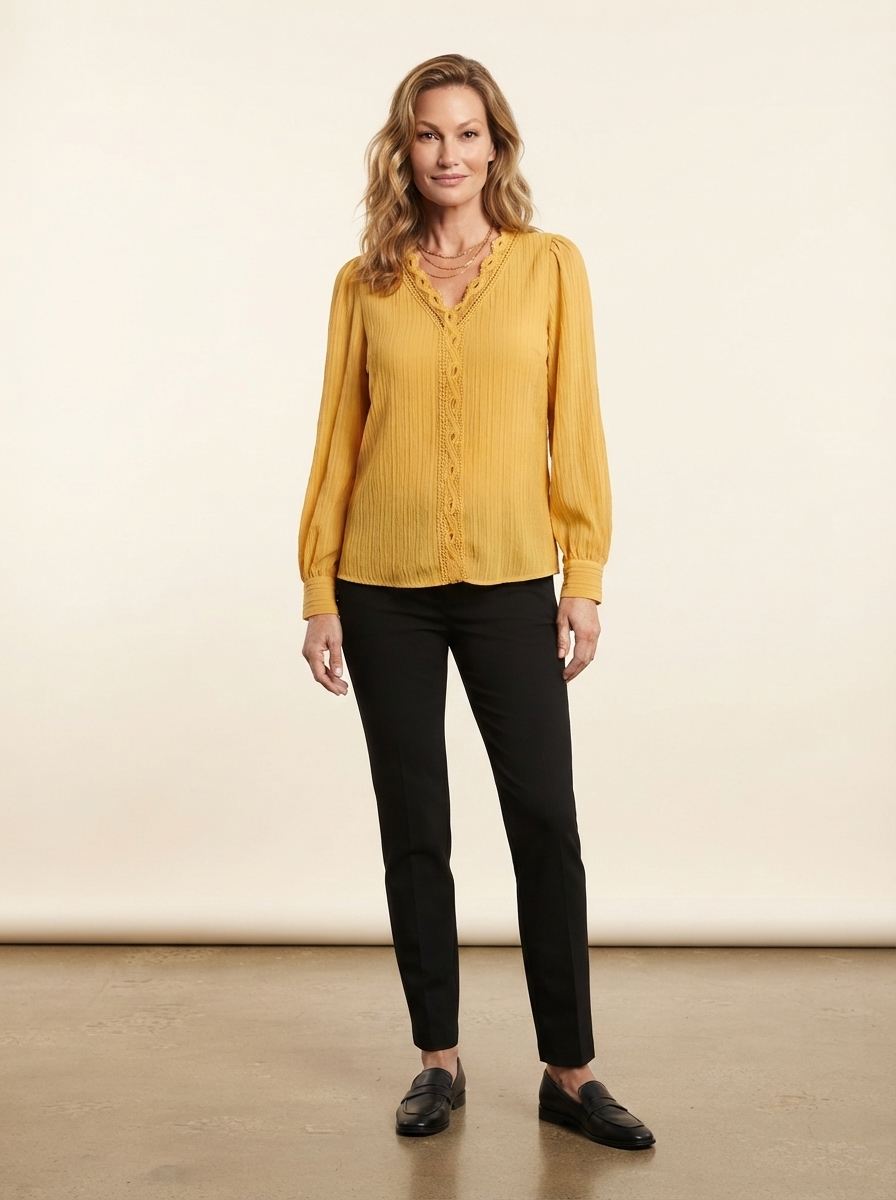Model wearing yellow chiffon blouse with lace details