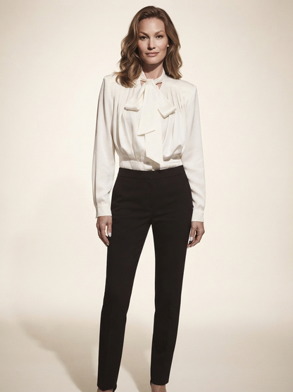 Model wearing white tie-waist long sleeve blouse