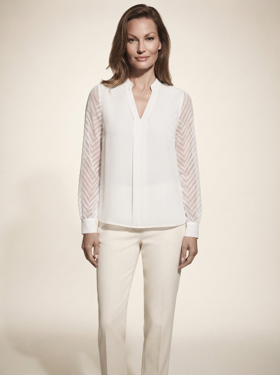 Model wearing white chiffon blouse with sheer textured sleeves