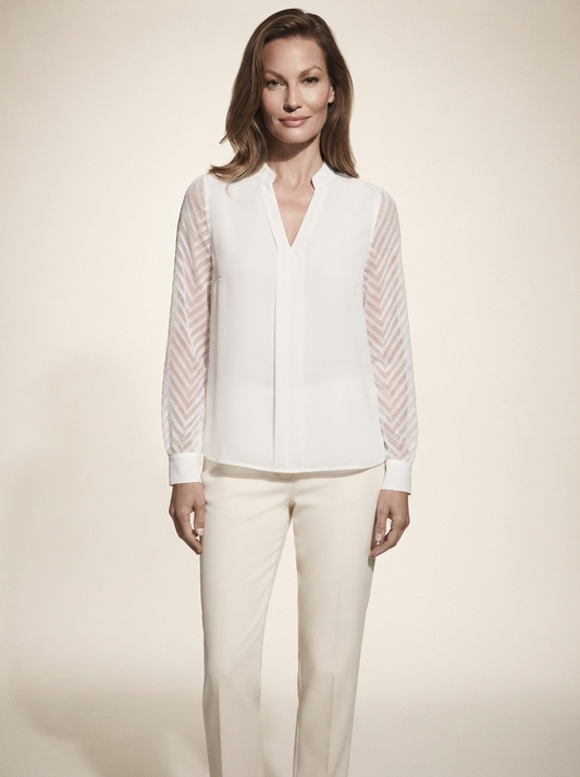 Model wearing white chiffon blouse with sheer textured sleeves