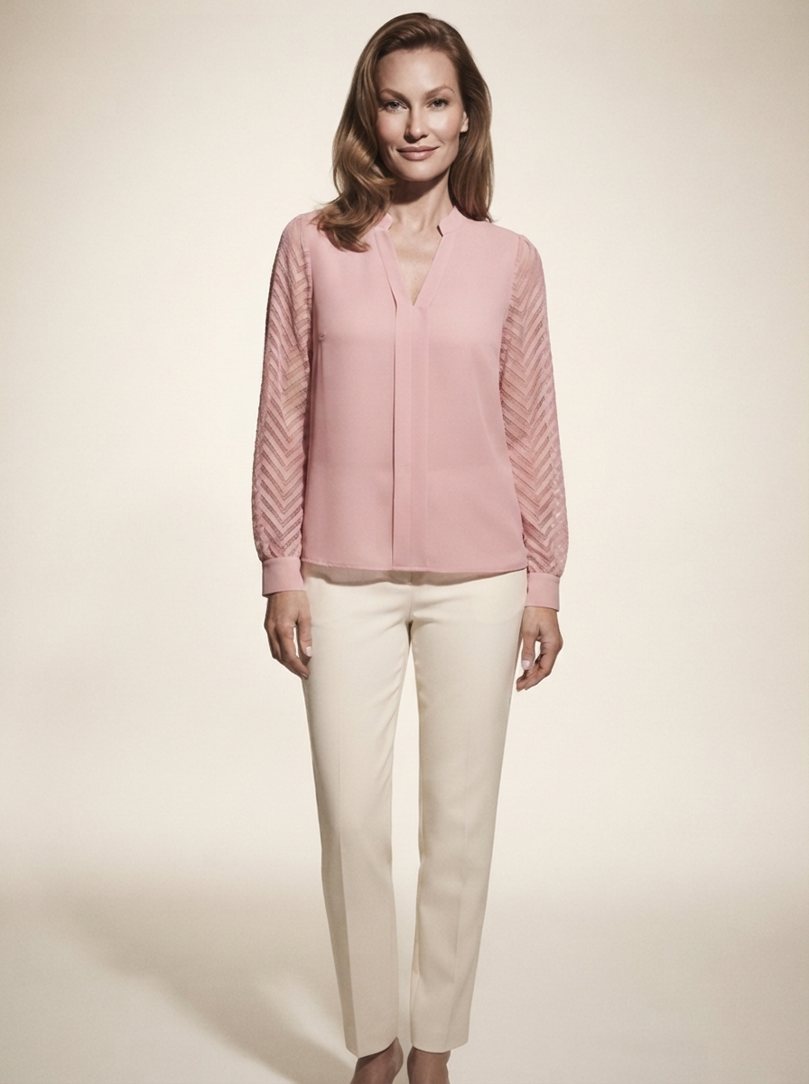 Model wearing pink chiffon blouse with sheer textured sleeves