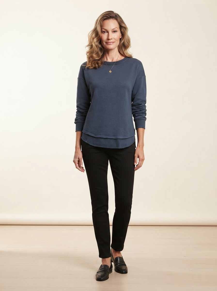 Model wearing dark blue asymmetric stitch knit sweater