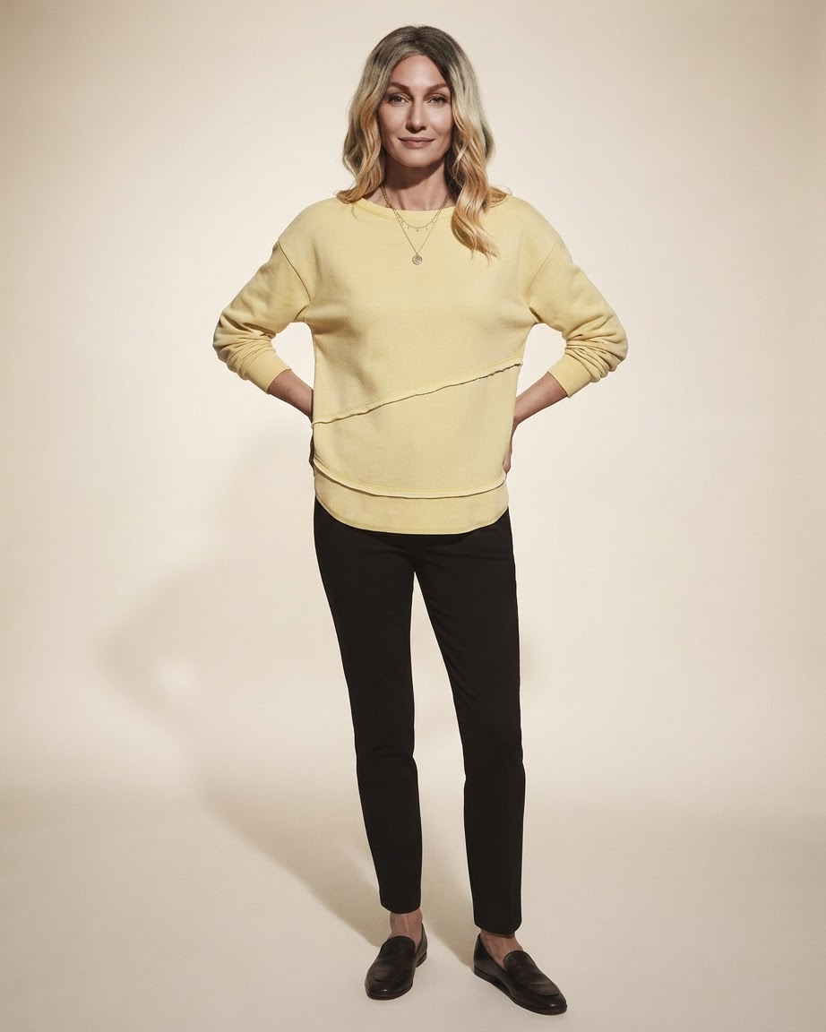Model wearing yellow asymmetric stitch knit sweater