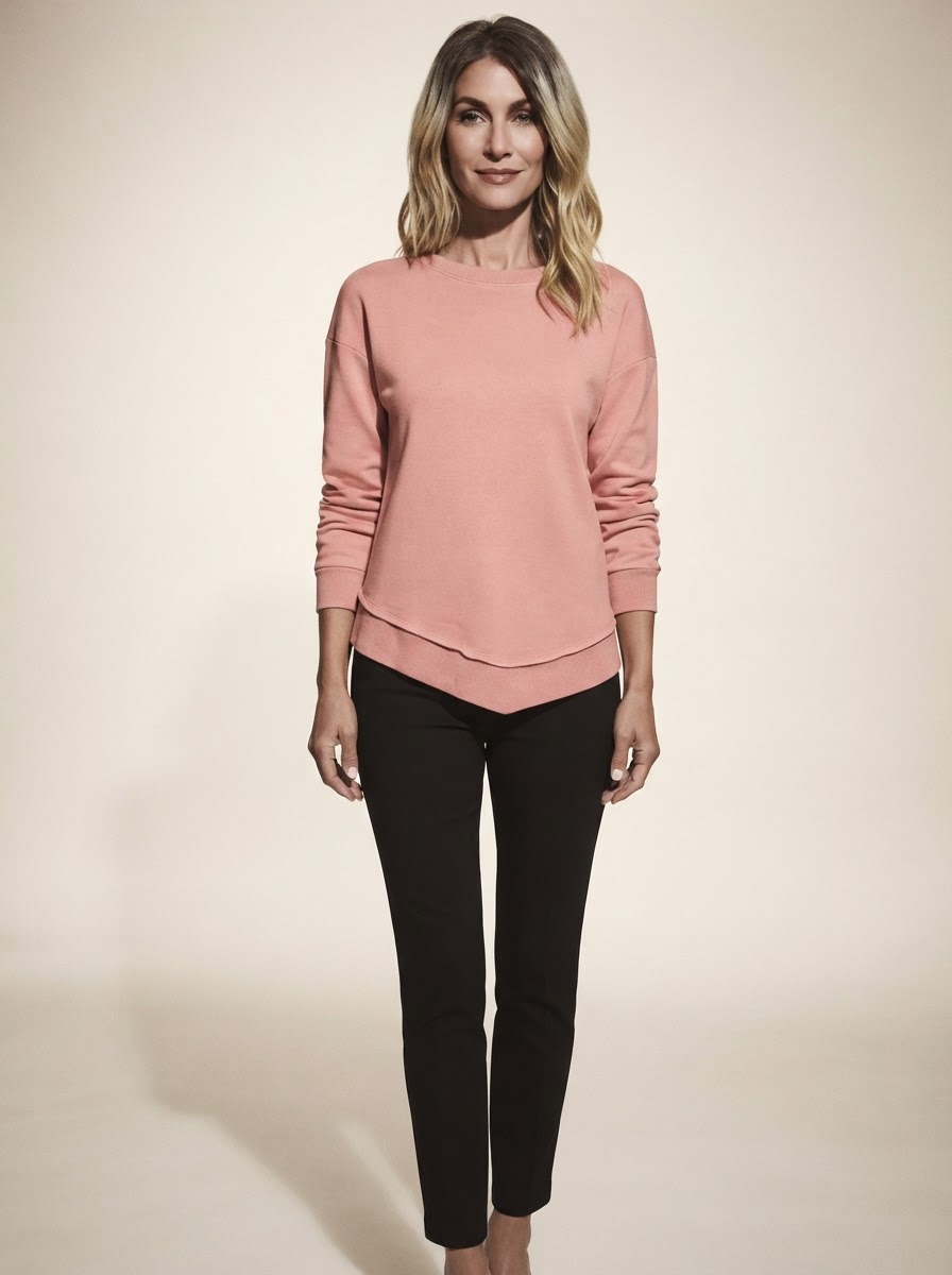 Model wearing pink asymmetric stitch knit sweater
