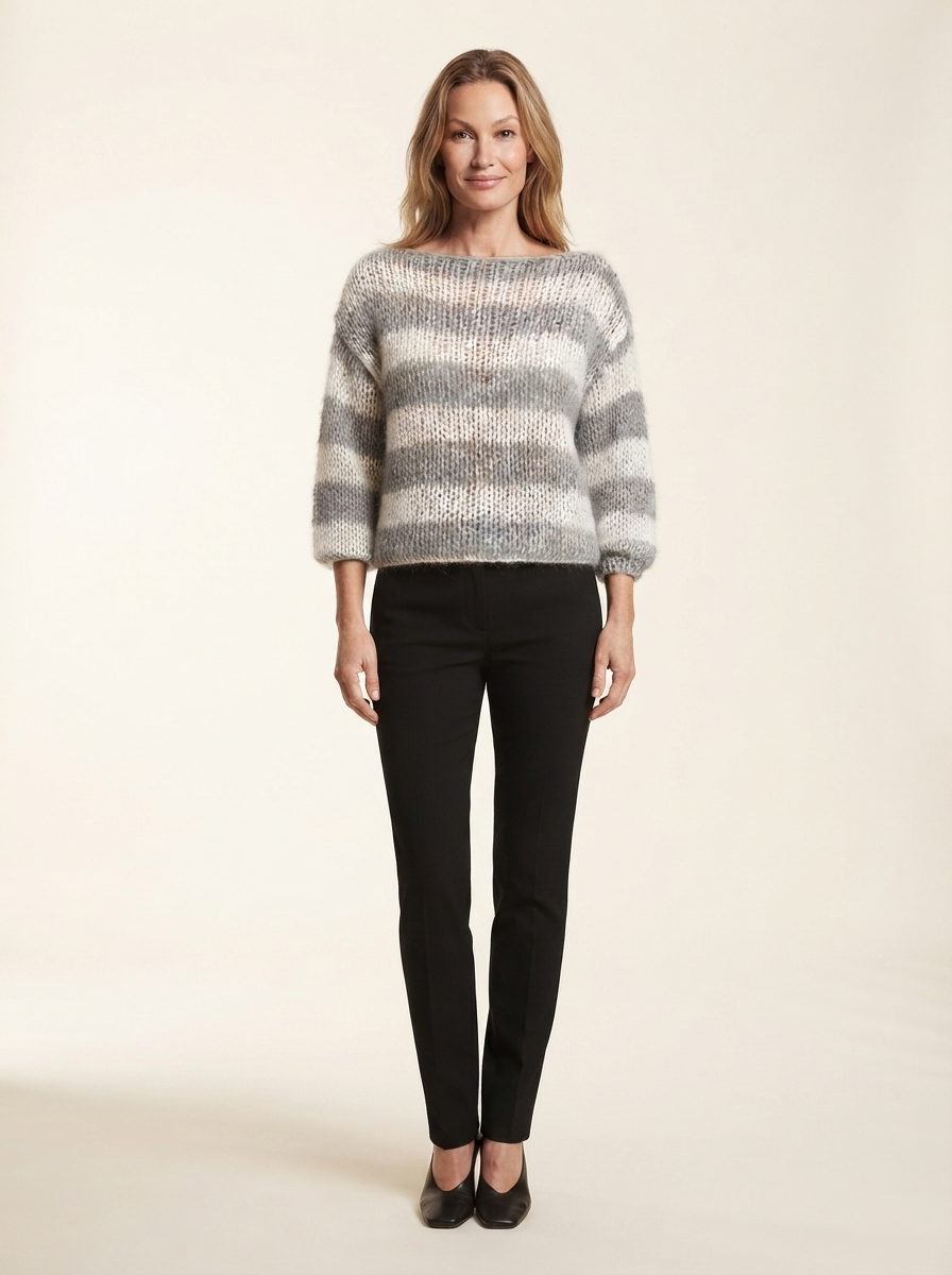 Model wearing gray striped knit pullover sweater