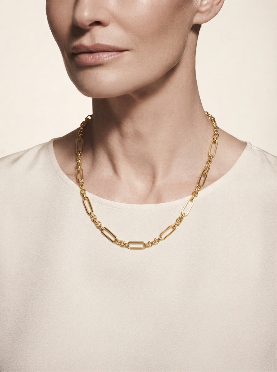 Close-up of model wearing gold-tone oval link chain necklace