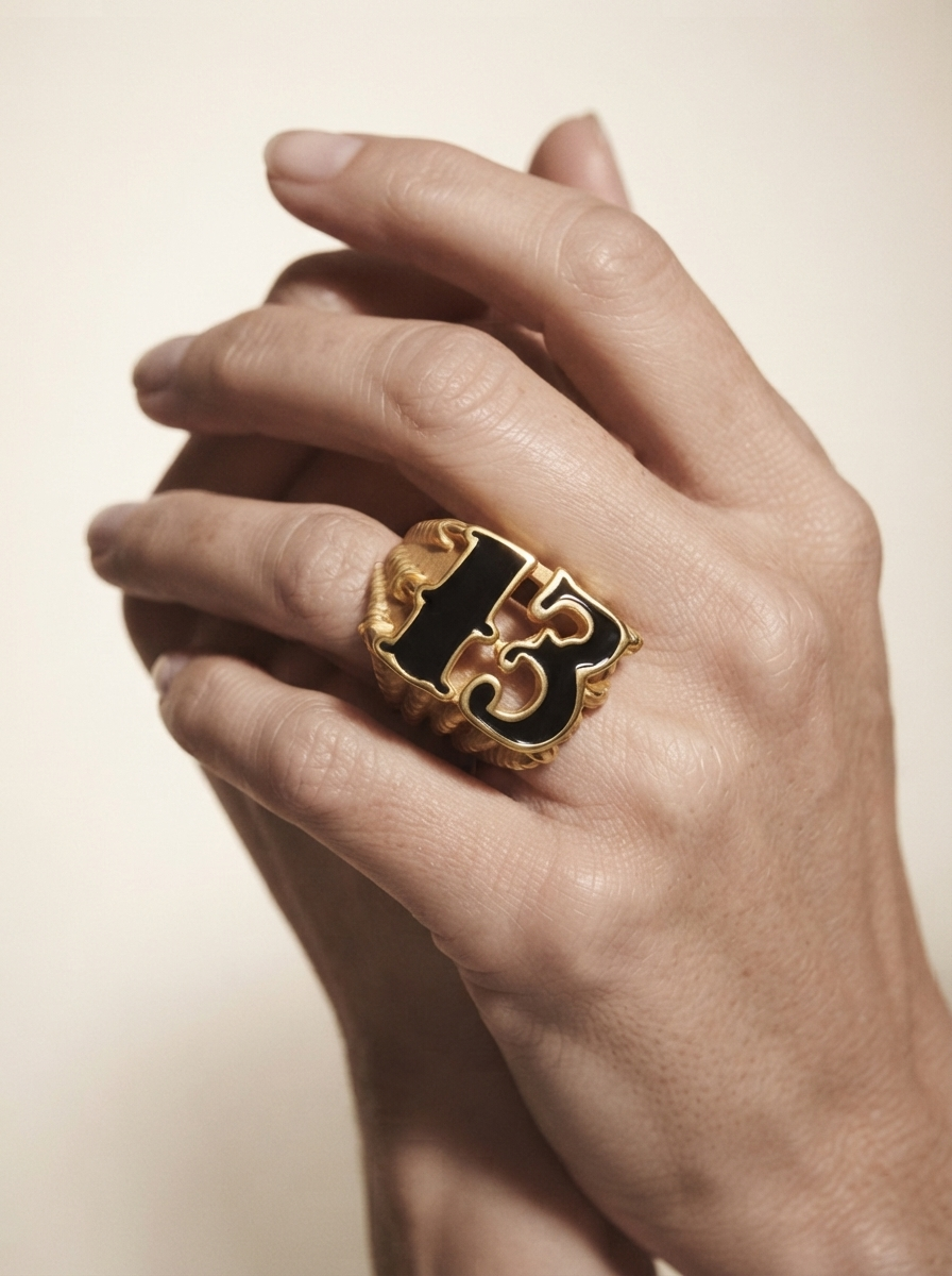 Close-up of model wearing gold-tone black enamel statement ring