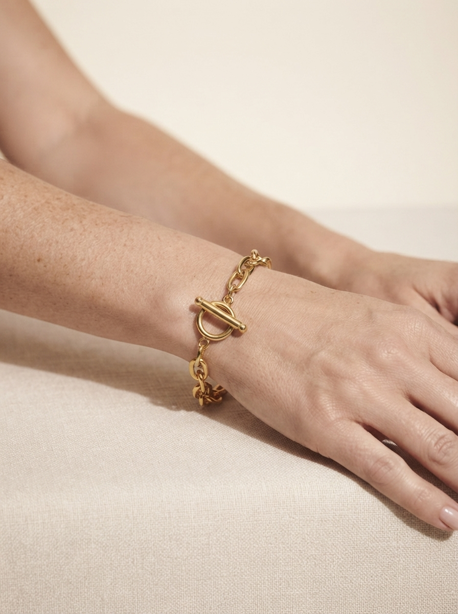 Close-up of model wearing minimalist gold-tone chain bracelet