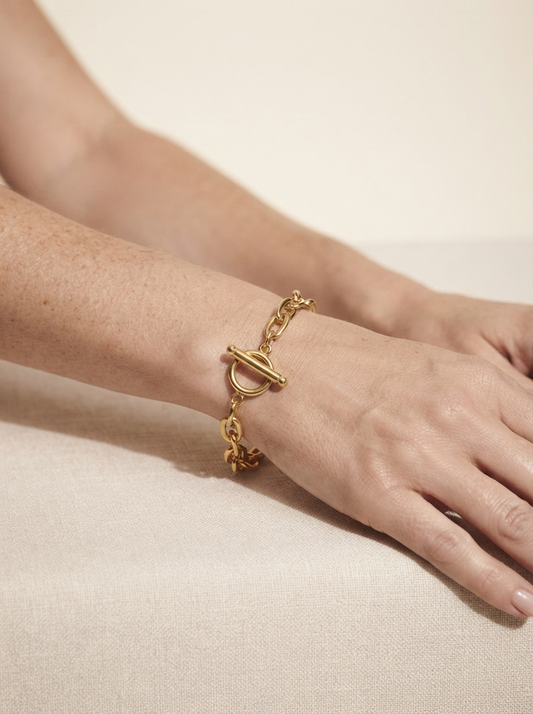 Close-up of model wearing minimalist gold-tone chain bracelet