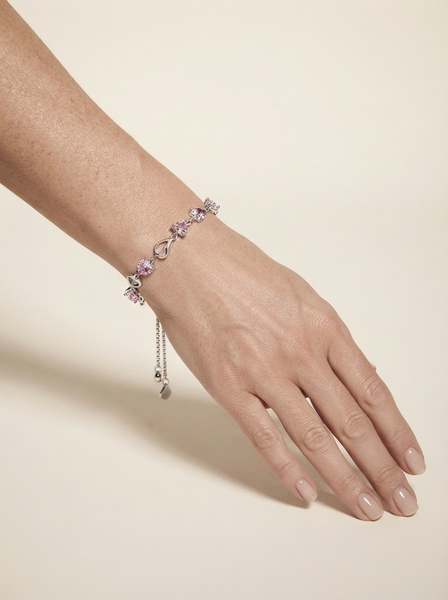 Close-up of model wearing pink crystal heart bracelet