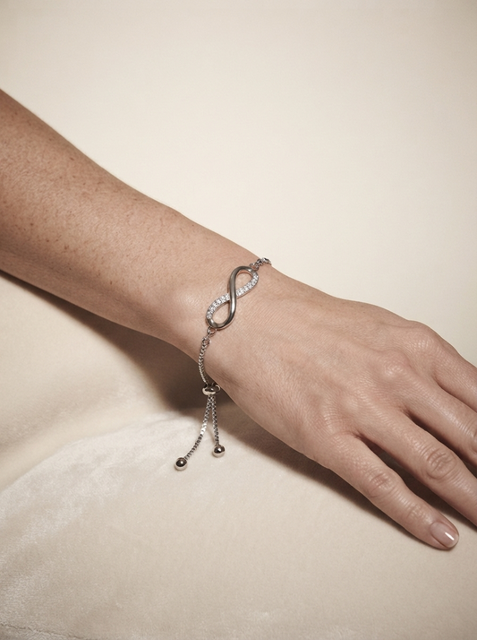Close-up of model wearing platinum adjustable figure-8 crystal bracelet