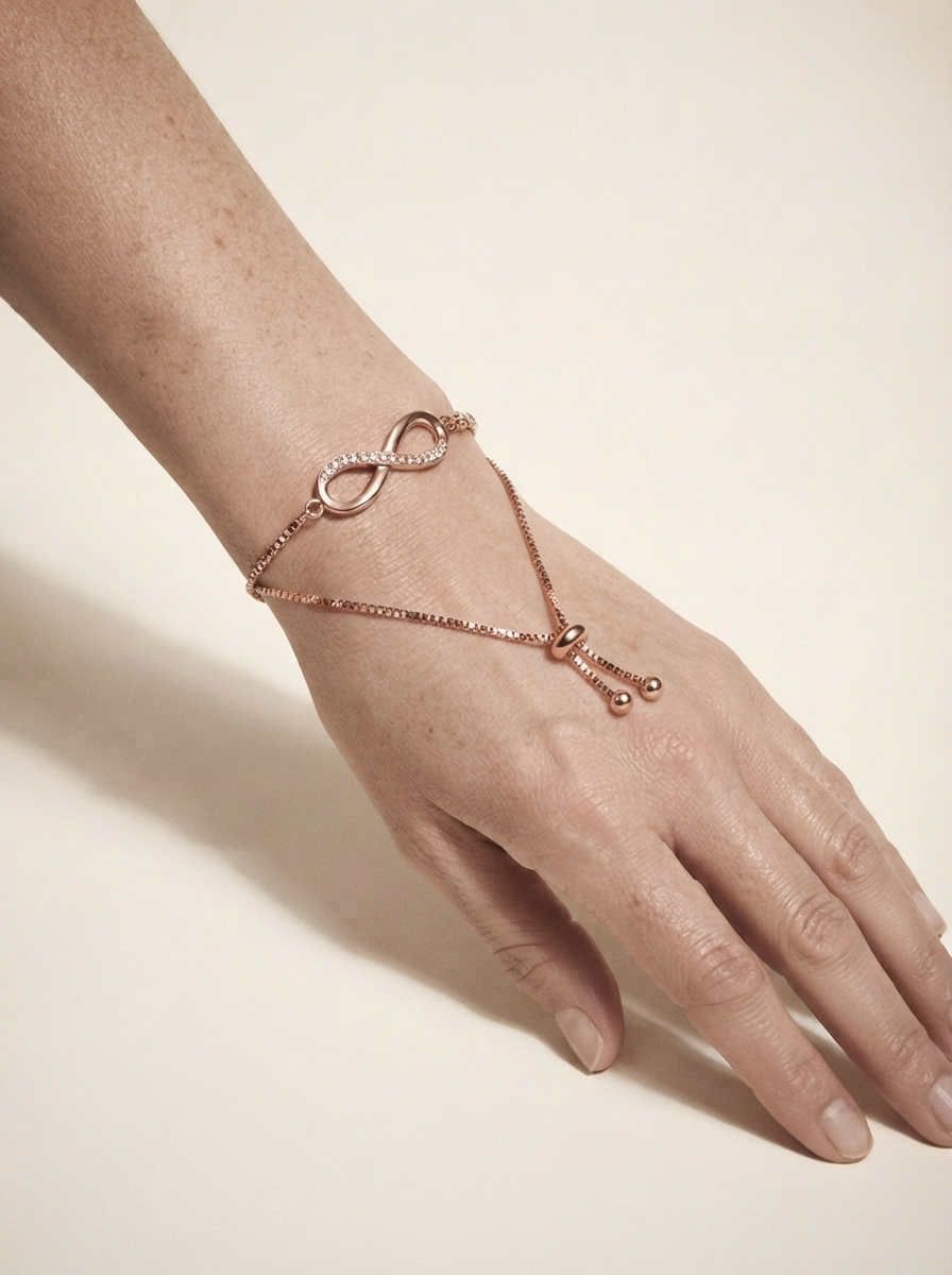 Close-up of model wearing rose gold adjustable figure-8 crystal bracelet