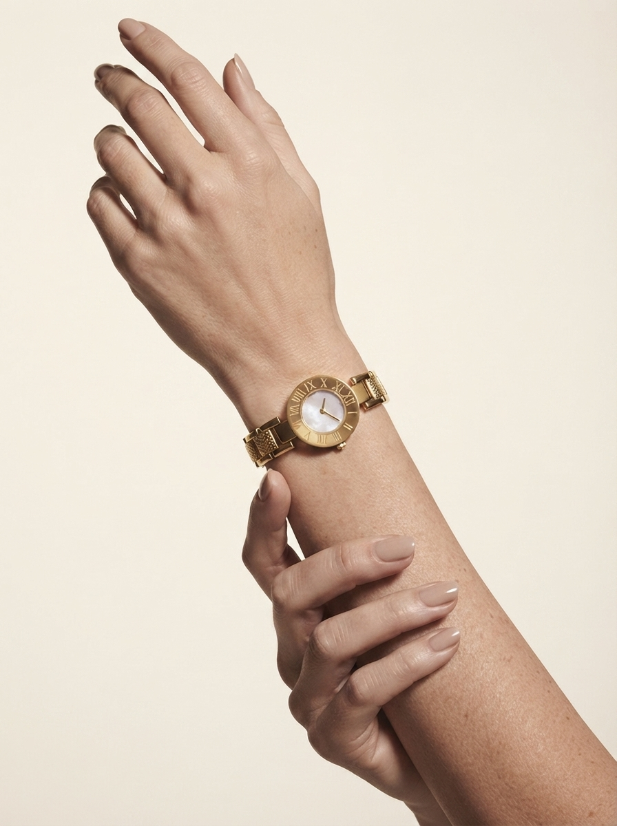 Close-up of model wearing gold-tone roman numeral watch with bracelet