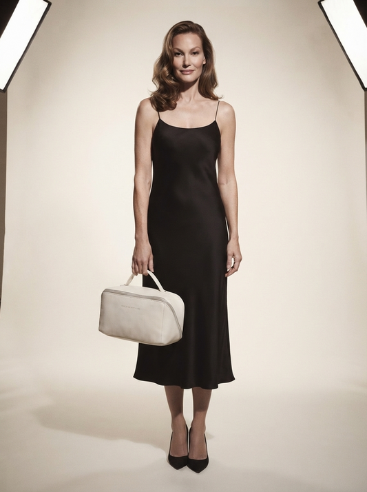 Model holding white vegan leather travel wash bag