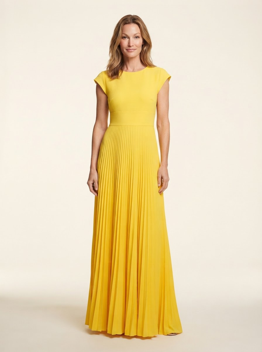 Model wearing yellow high-waist pleated maxi dress