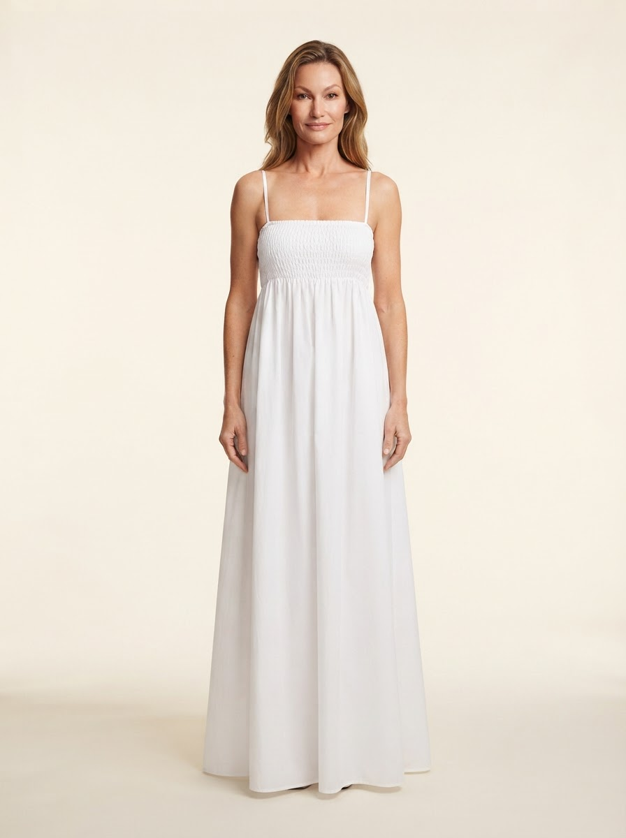 Model wearing white spaghetti strap smocked maxi dress