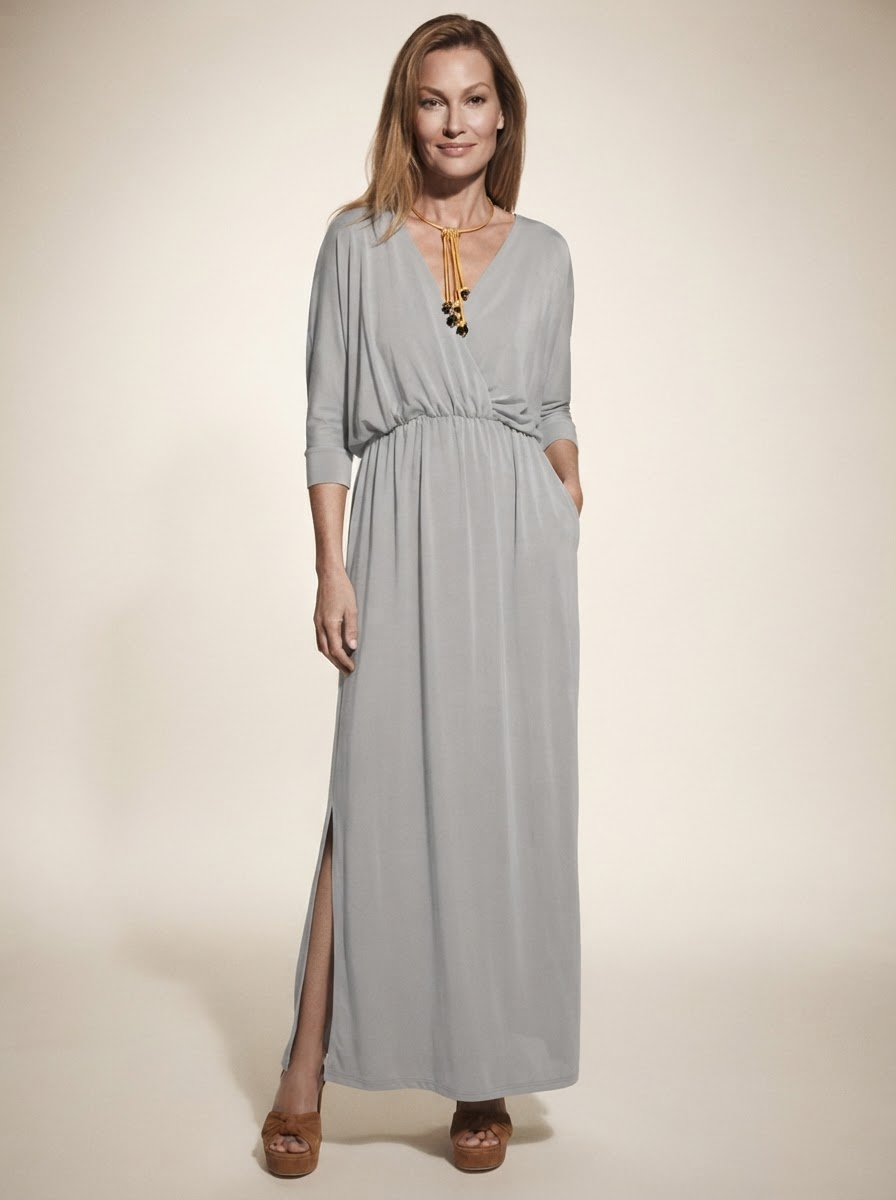 Model wearing light gray v-neck side-slit maxi dress