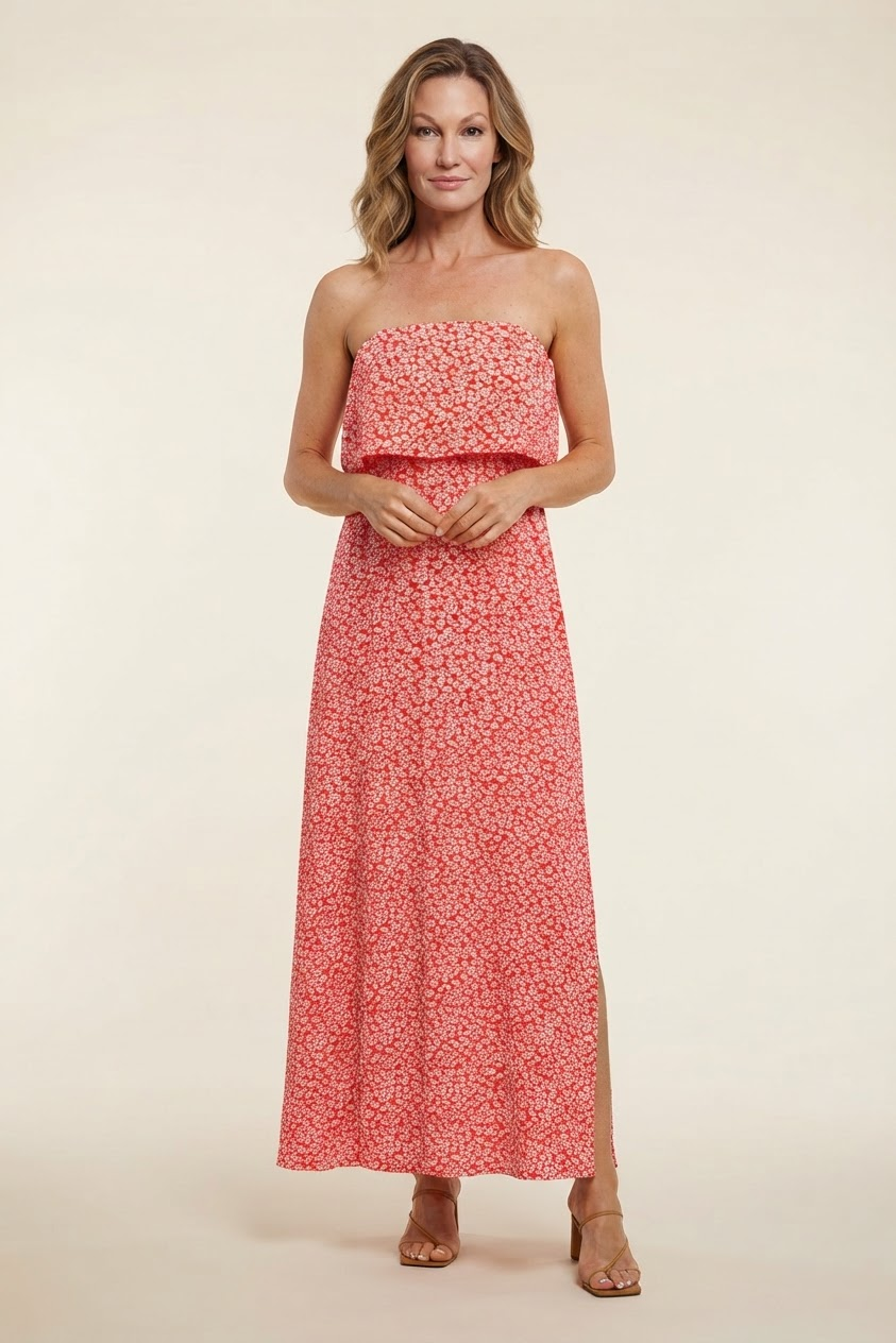 Model wearing red small floral tube top dress with slit